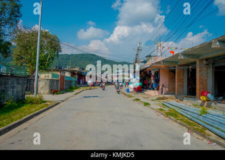 POKHARA, NEPAL - OCTOBER 06 2017: Outdoor view of different buildings with a pavement street, with some cables lines in Pokhara, Nepal Stock Photo