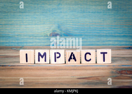impact - name from wooden letters. Office desk, informative and communication background Stock Photo