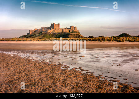 Bamburgh Castle is a castle on the northeast coast of England, by the village of Bamburgh in Northumberland. It is a Grade I listed building. Stock Photo