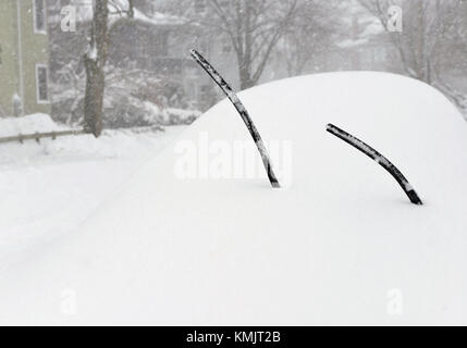 Car covered in snow, windshield wipers sticking out Stock Photo