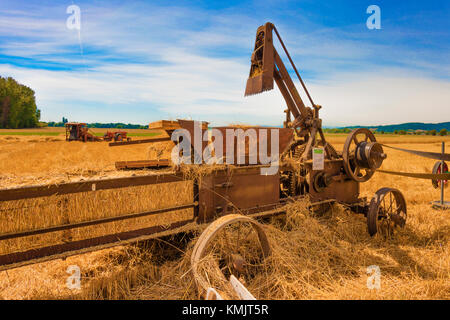 McMinnville, Oregon, USA - August 13, 2016:  An old straw baler on display at Yamhill County Harvest Festival. Stock Photo