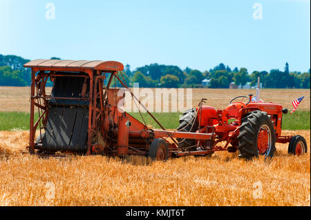 McMinnville, Oregon, USA - August 13, 2016:  An old tractor pulling an implement at Yamhill County Harvest Festival. Stock Photo