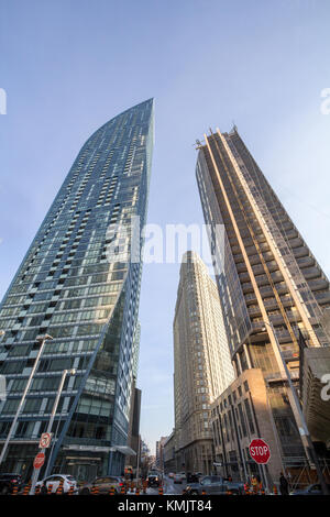 TORONTO, CANADA - DECEMBER 20, 2016:Modern skyscrapers, one being built with scaffolds and cranes in downtown Torono, Ontario, Canada during a sunny w Stock Photo