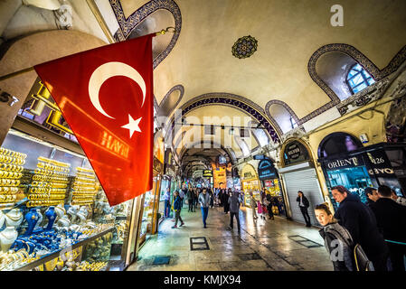 Unidentified Tourists visiting and shopping in the Grand Bazaar in Istanbul. Interior of the Grand Bazaar with Turkish Flag on the foreground.Istanbul Stock Photo