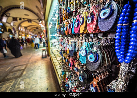 Unidentified Tourists visiting and shopping in the Grand Bazaar in Istanbul. Interior of the Grand Bazaar with souvenirs on the foreground.Istanbul, T Stock Photo