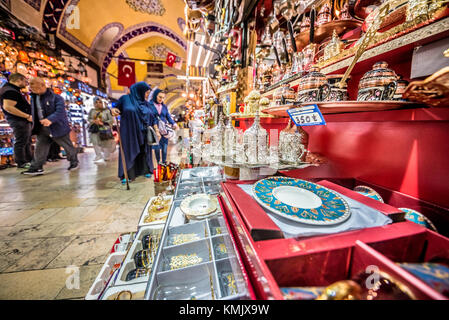 Unidentified Tourists visiting and shopping in the Grand Bazaar in Istanbul. Interior of the Grand Bazaar with souvenirs on the foreground.Istanbul, T Stock Photo