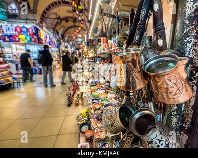 Unidentified Tourists visiting and shopping in the Grand Bazaar in Istanbul. Interior of the Grand Bazaar with souvenirs on the foreground.Istanbul, T Stock Photo