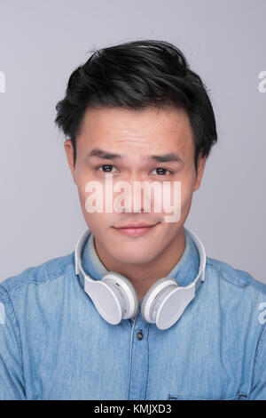 Smart casual asian man with headphone in studio background Stock Photo