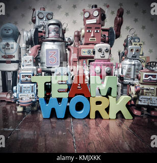 Concept TEAM WORK  wirh wooden letters and vintage robot toys Stock Photo