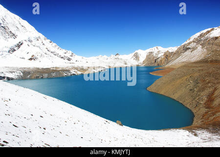 Tilicho Lake is situated at an altitude of 4,919 metres in the Annapurna range of the Himalayas and is the highest lake for its size in the world. Stock Photo