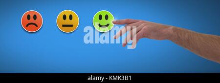 Digital composite of Hand pointing at feedback smiley faces satisfaction Stock Photo