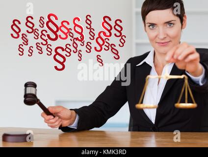 Digital composite of Justice gavel and balance scales and section symbol icons Stock Photo