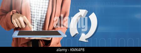 Digital composite of Hand holding tablet with 3D refresh arrows icon Stock Photo