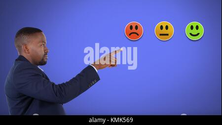 Digital composite of Man pointing at smiley faces feedback satisfaction icons Stock Photo