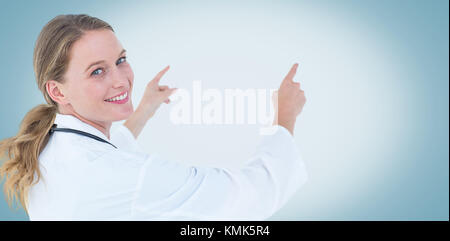 Young doctor pointing on white background Stock Photo