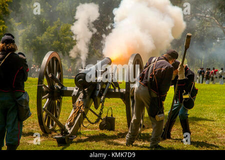 A 'Union' artillery crew fires a cannon at a Civil War battle reenactment in a Huntington Beach, CA, park. Stock Photo