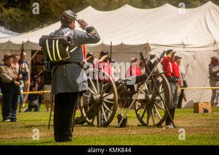 A 'Confederate' soldier salutes his 'Union' adversary at the conclusion pf a Civil War battle reenactment in a Huntington Beach, CA, park. Stock Photo