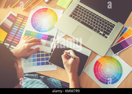 Graphic designer drawing on graphics tablet at workplace Stock Photo