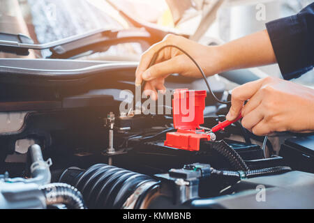 Hands check battery car mechanic working in auto repair service Stock Photo