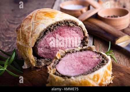 Beef Wellington, classic steak dish on rustic wooden table Stock Photo
