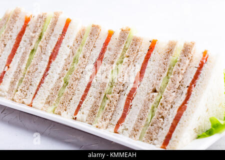 English tea sandwiches platter on white plate over light background Stock Photo