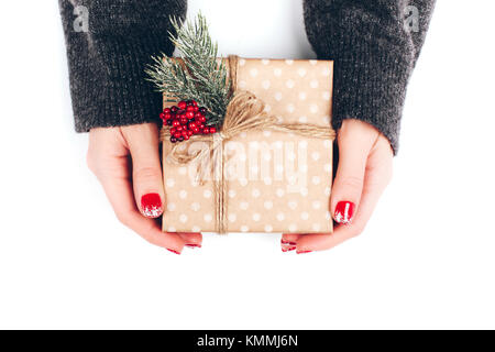 Woman's hands wrapping Christmas gift box Stock Photo