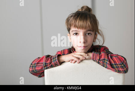 Portrait Of 10 Year Old Girl With Serious Face On A White