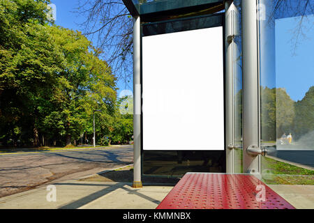 Bus stop advertising. Blank billboard on bus shelter, poster size, vertical Stock Photo