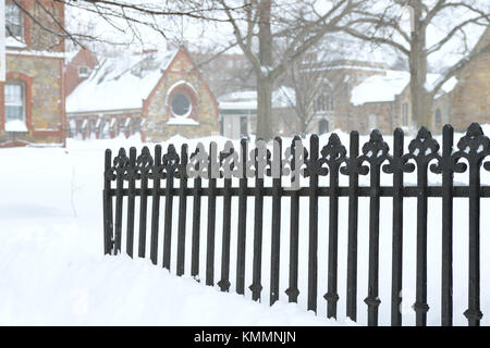 Cast iron fence burried in snow. Winter background Stock Photo