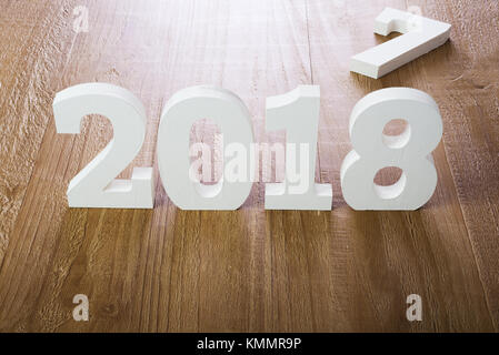 White digits 2018 and digit 7 on rustic  wooden background as concept of New Year and Christmas. Stock Photo