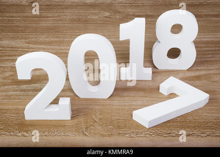 White digits 2018 and digit 7 on rustic  wooden background as concept of New Year and Christmas. Stock Photo