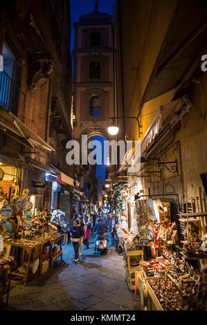 NAPLES, ITALY - OCTOBER 16, 2017: Night time view of the famous 'Christmas Alley' (Via San Gregorio Armeno) home to the Neapolitan Nativity scene. Stock Photo