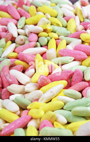 Candy from puffed rice grains. Sweet flavored puffed rice grains. Colorful snack. Stock Photo