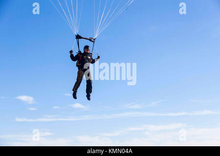 A U.S. Army paratrooper from the U.S. Army Parachute Team (Golden Knights) descends on Luzon Drop Zone during the 20th Annual Randy Oler Memorial Operation Toy Drop, at Camp MacKall, North Carolina, Dec. 4, 2017. This year, eight countries are participating and they include; Colombia, Canada, Latvia, the Netherlands, Sweden, Italy, Germany, and Poland. Operation Toy Drop, hosted by the U.S. Army Civil Affairs & Psychological Operations Command (Airborne) is the largest combined airborne operation conducted worldwide. The event allows Soldiers the opportunity to train on their military occupati Stock Photo