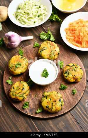 Vegetable cutlet from carrot, zucchini, potato with sauce. Healthy diet vegetarian food. Stock Photo