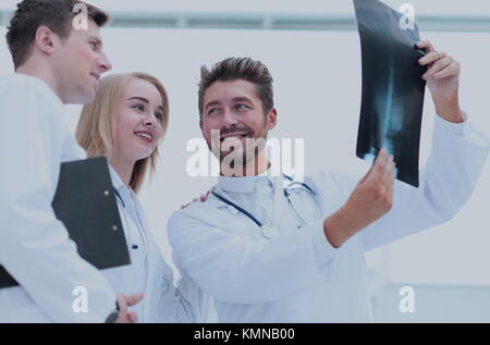 Handsome bearded doctor smiling confidently while discussing wit Stock Photo