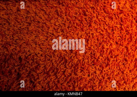 Close up of bright red domestic woolen carpet texture Stock Photo