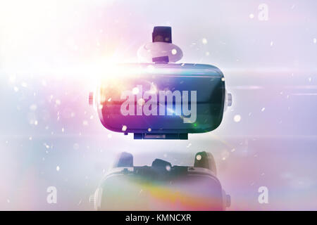 Black and white virtual reality glasses close up with colored lights on white metraquilate table and white isolated background. Horizontal composition Stock Photo