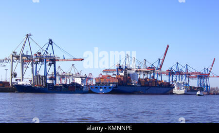 HAMBURG, GERMANY - MARCH 8th, 2014: View on the Burchardkai of the Hamburg harbor. Container ship TABEA is unloaded and loaded during a clear blue sky day Stock Photo