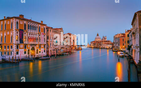 View on Venice: a view at dusk over the Canal Grande from the Accademia Bridge towards the church Santa Maria della Salute. Stock Photo