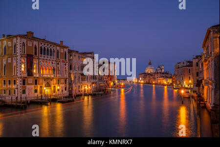 View on Venice: a view at dusk over the Canal Grande from the Accademia Bridge towards the church Santa Maria della Salute. Stock Photo