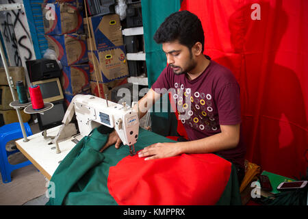 Dhaka, Bangladesh. 09th Dec, 2017. Victory day is a national holiday in Bangladesh celebrated on December 16 to commemorate the victory of the Allied forces High Command over the Pakistani forces in the Bangladesh Liberation War in 1971. A young tailor sewing cloth and making Bangladeshi national flags for selling Upcoming 16 December events. Credit: Jahangir Alam Onuchcha/Alamy Live News Stock Photo