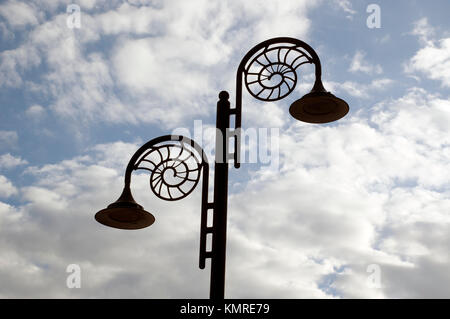Decorative street lamps in the shape of ammonite fossils, on the Jurassic Coast at Lyme Regis, Dorset. Stock Photo
