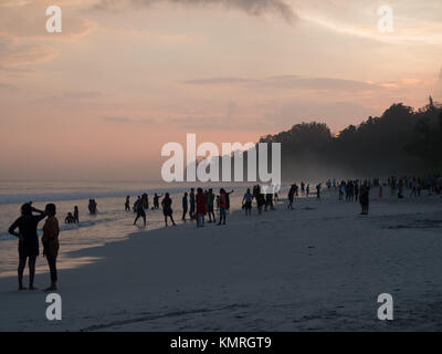 People silhouettes at sunset in Radhanagar beach, Havelock Stock Photo