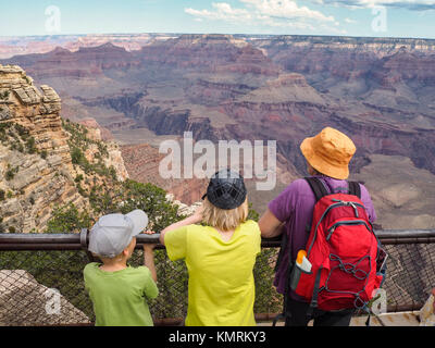 A tourist family is overlooking the Grand Canyon National Park from the South Rim Stock Photo