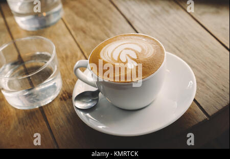 Closeup of barista made coffee with froth art Stock Photo