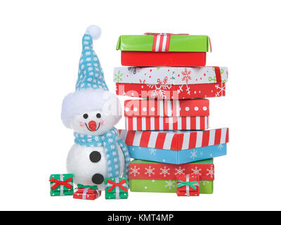 Small snowman standing next to a pile of colorful boxes Christmas Presents stacked high above his head. Isolated on white background Stock Photo