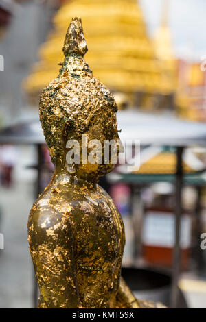 Bangkok, Thailand.  Buddha Statue Covered with Gold Leaf Placed by Worshipers, Royal Grand Palace Compound. Stock Photo