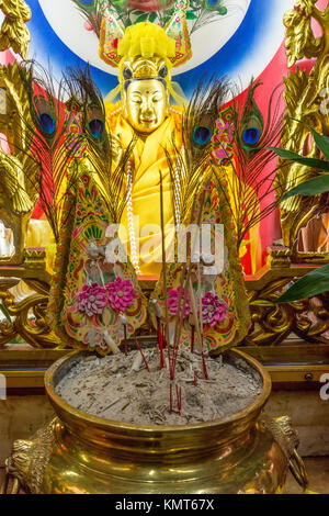 Bangkok, Thailand.  Incense Offering before Tubtim (Tub Tim), a Chinese Goddess of Fertility.  Monkey King Shrine, Chinatown. Stock Photo