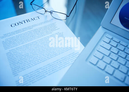 Image of document, eyeglasses and laptop on workplace Stock Photo